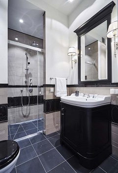 bathroom with wall lamps and a decorative mirror